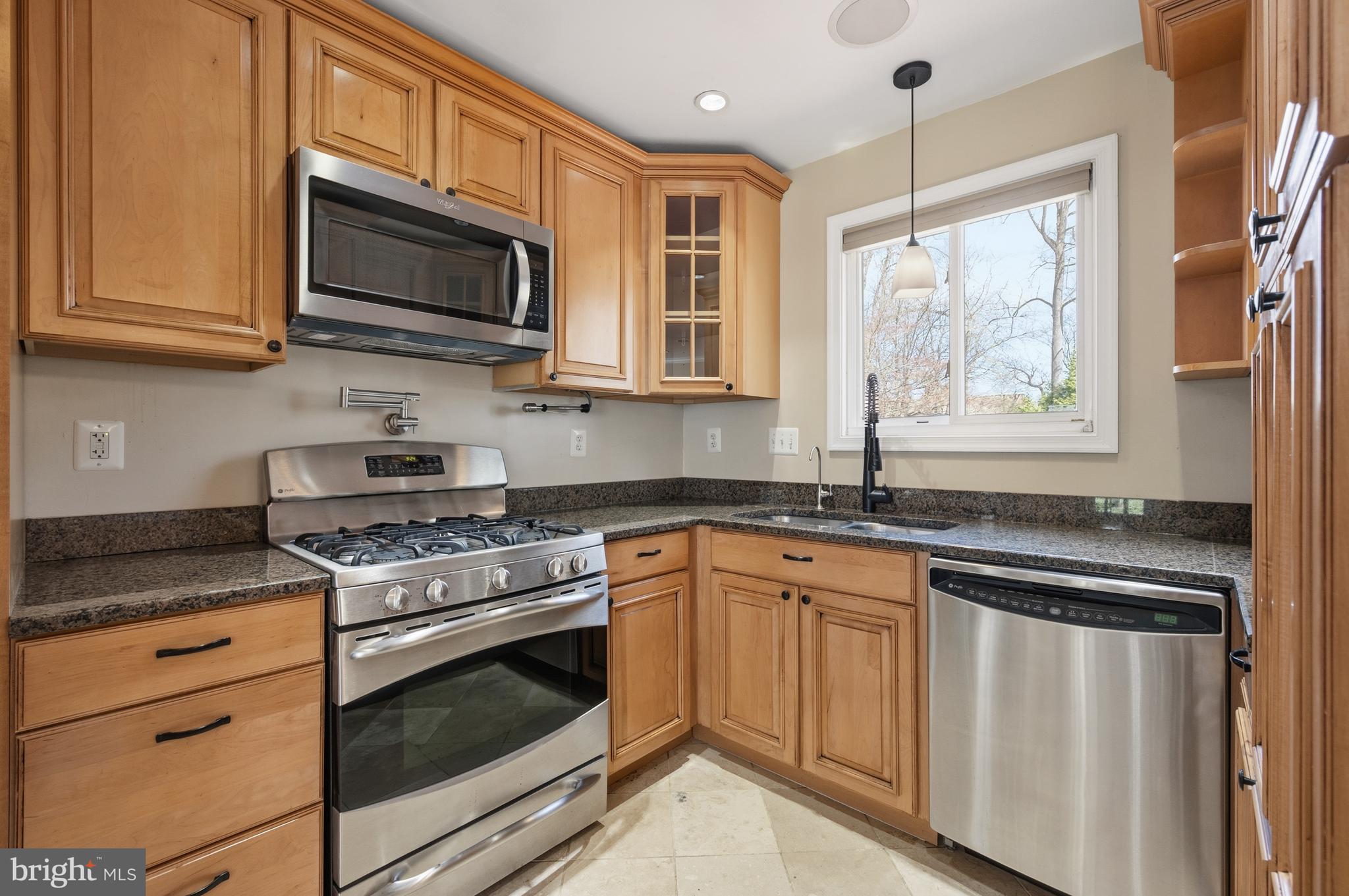 124 Woodland Road Gaithersburg, MD 20877 - Photo 16 of 79 a kitchen with stainless steel appliances granite countertop white cabinets granite counter tops and a window