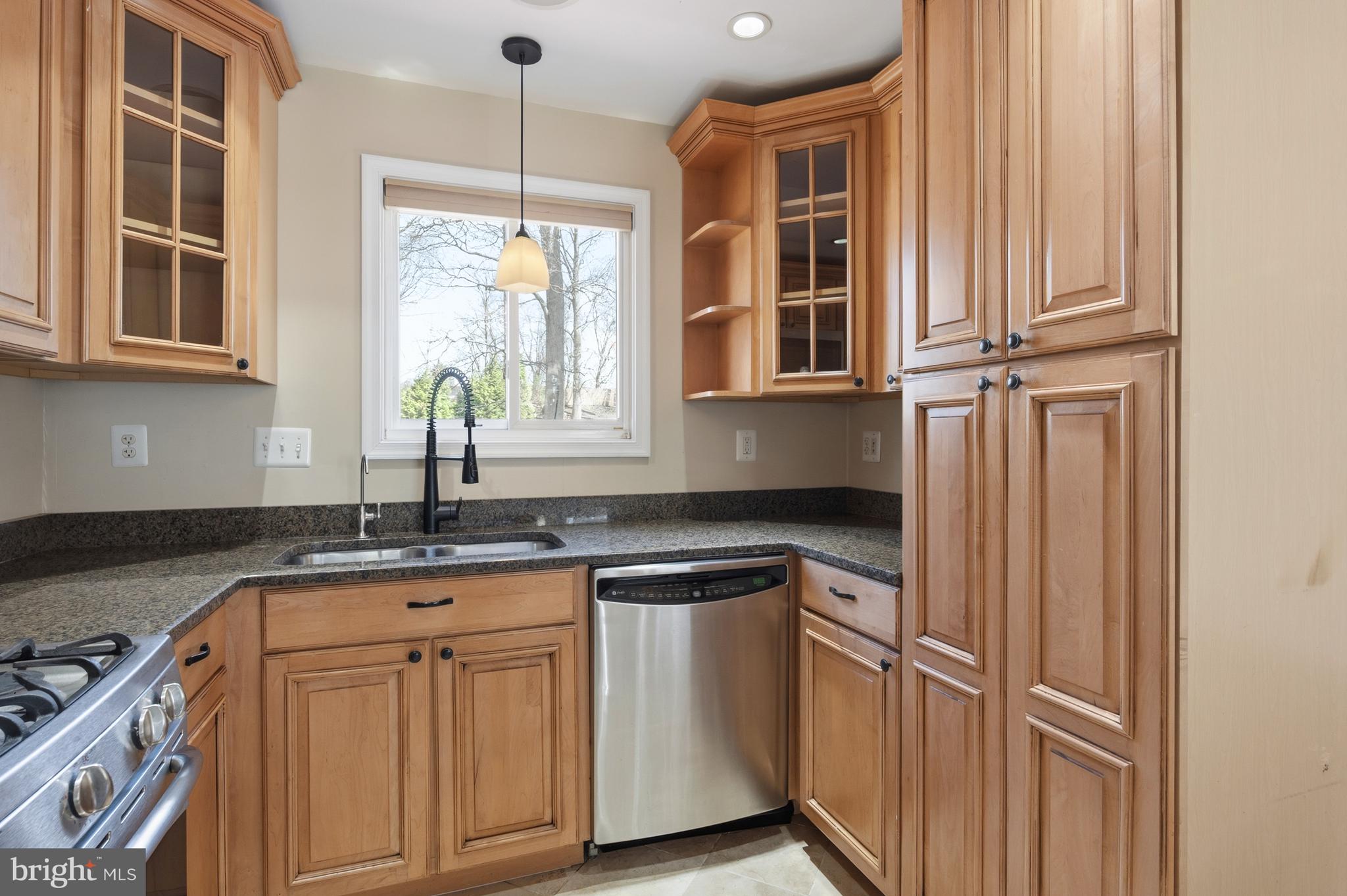 124 Woodland Road Gaithersburg, MD 20877 - Photo 17 of 79 a kitchen with granite countertop stainless steel appliances a stove and a window