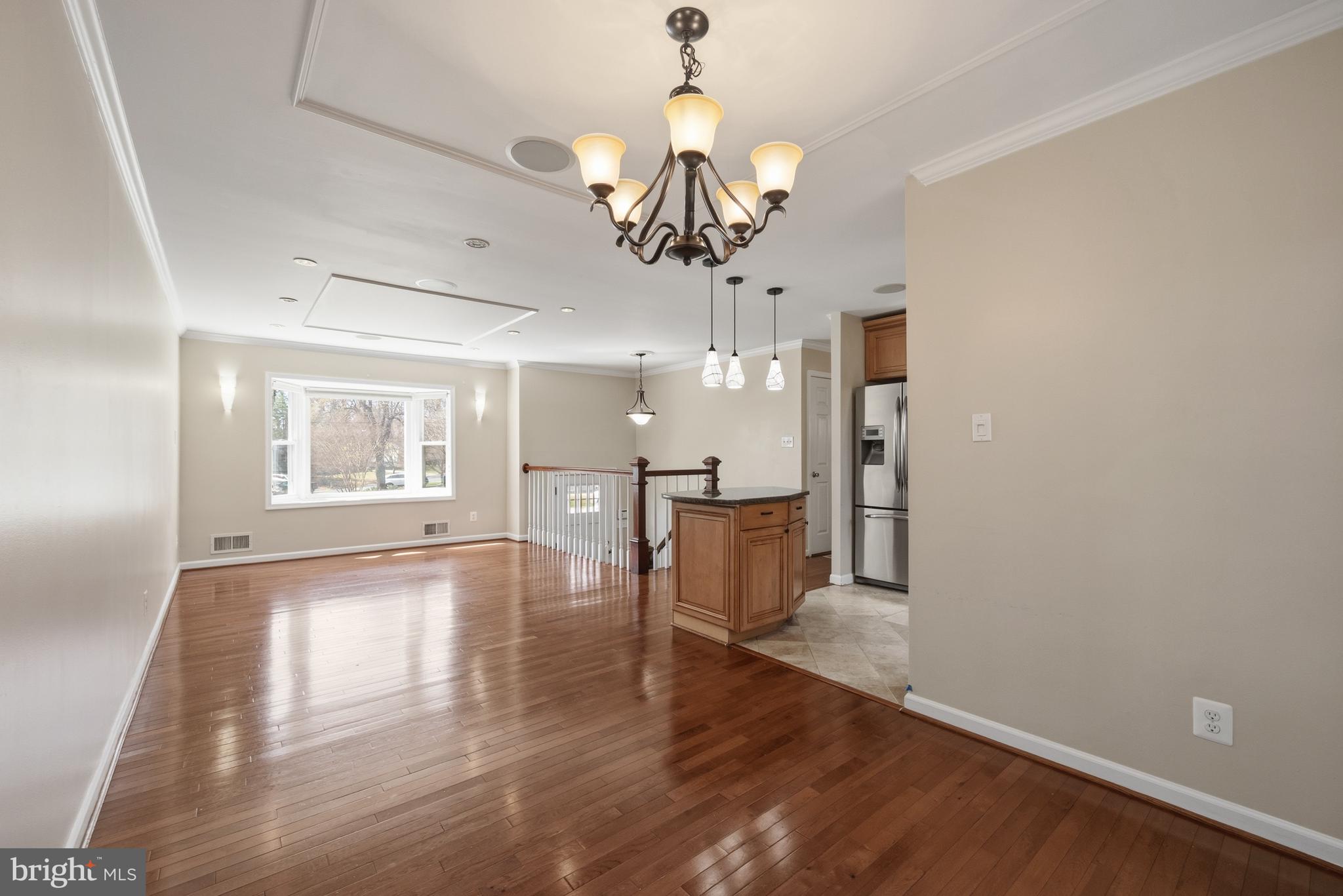 124 Woodland Road Gaithersburg, MD 20877 - Photo 19 of 79 a view of a room with wooden floor chandelier and windows