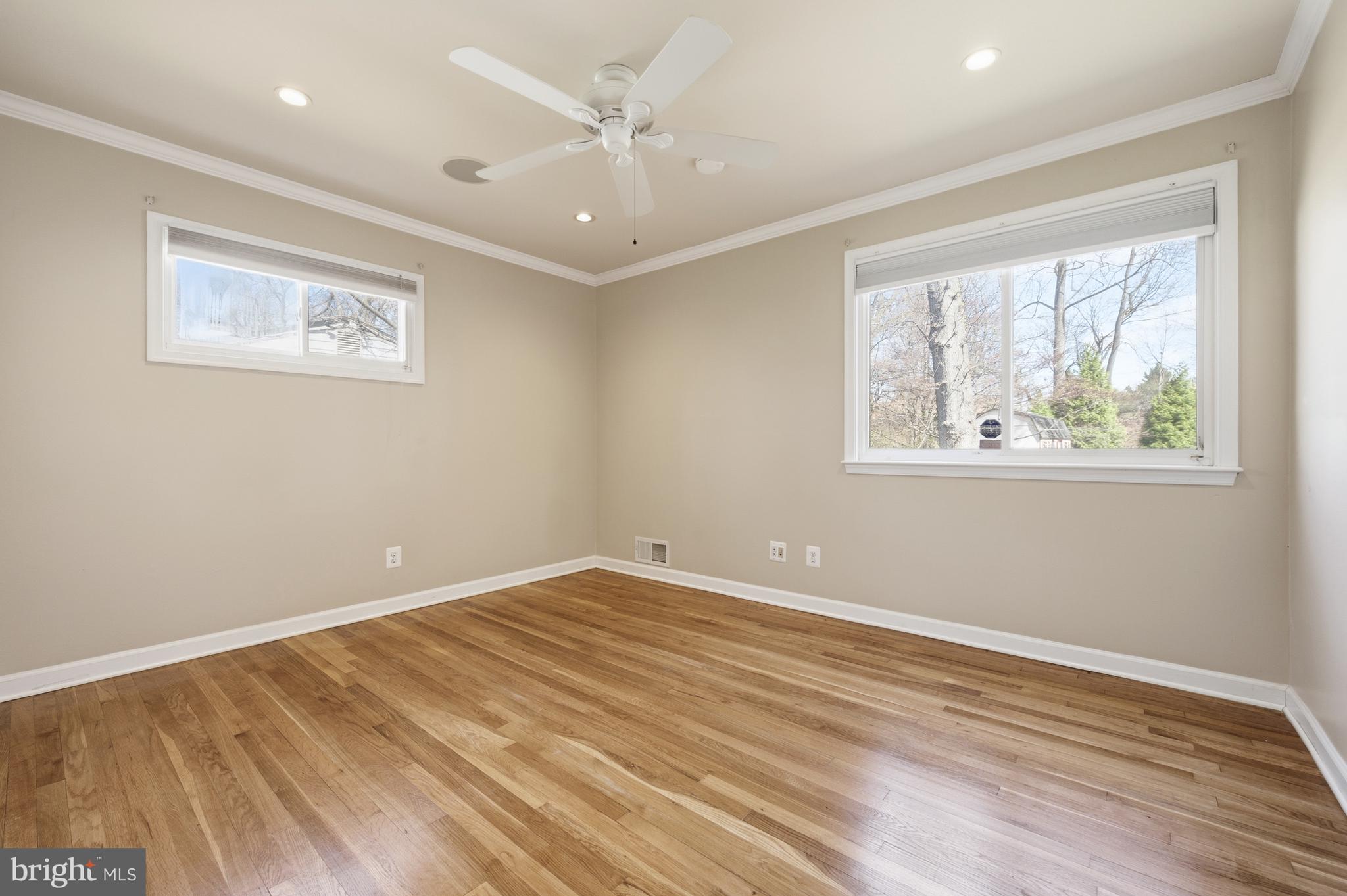124 Woodland Road Gaithersburg, MD 20877 - Photo 20 of 79 a view of empty room with wooden floor and fan
