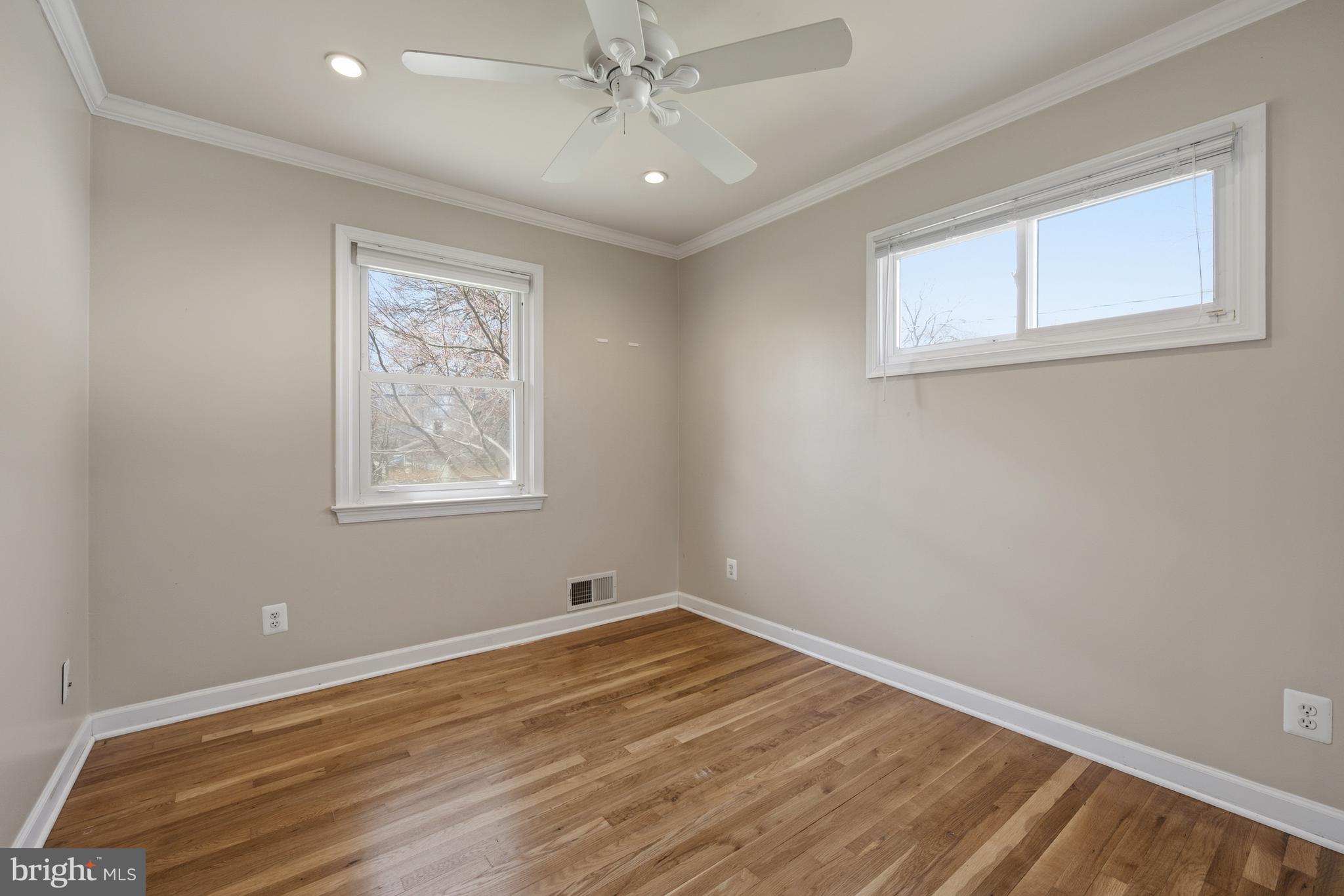 124 Woodland Road Gaithersburg, MD 20877 - Photo 23 of 79 a view of empty room with wooden floor and fan