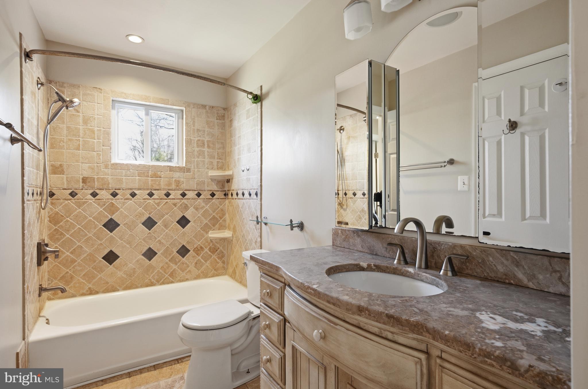 124 Woodland Road Gaithersburg, MD 20877 - Photo 26 of 79 a bathroom with a granite countertop sink toilet and shower