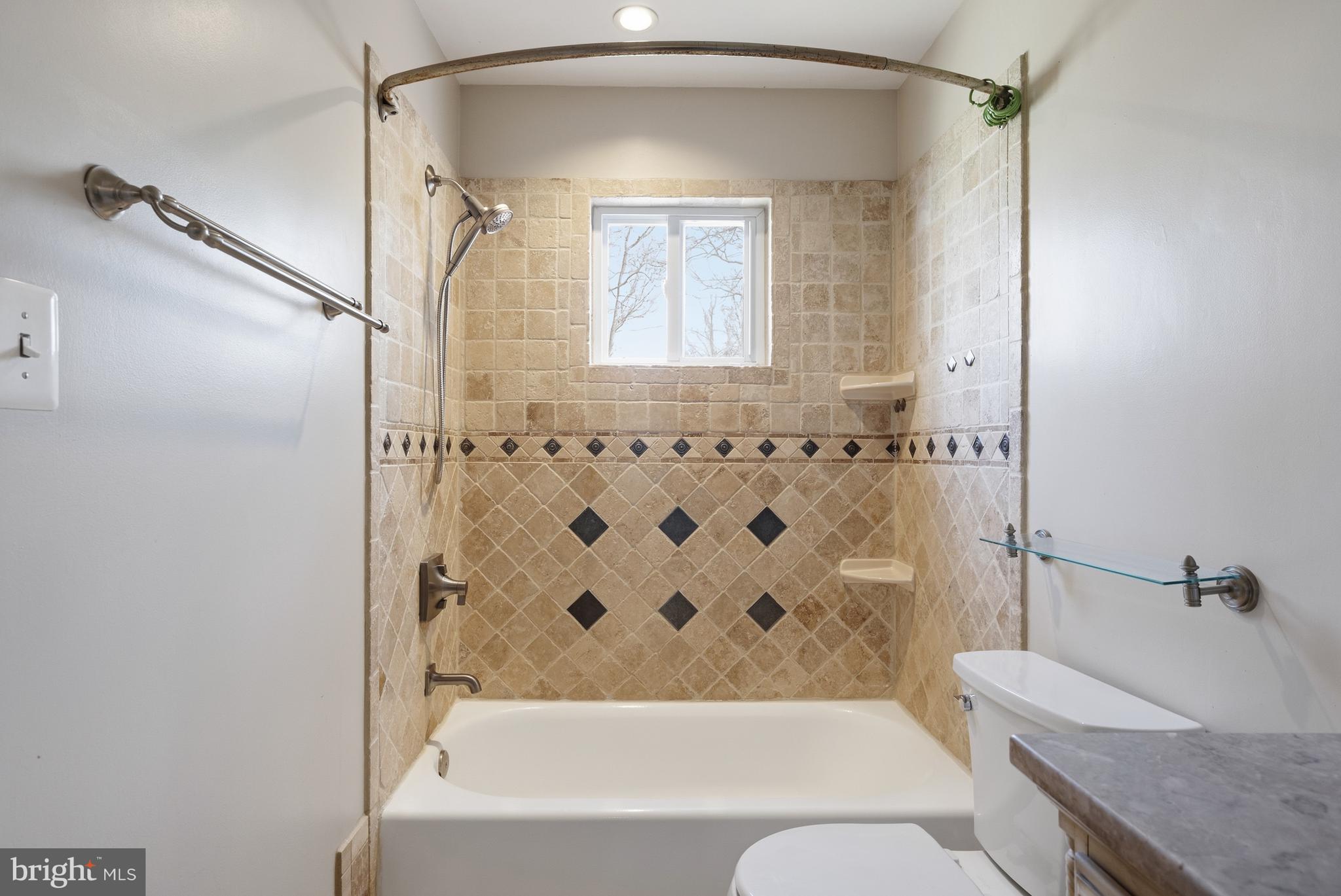 124 Woodland Road Gaithersburg, MD 20877 - Photo 27 of 79 a bathroom with a granite countertop bathtub shower sink vanity and toilet