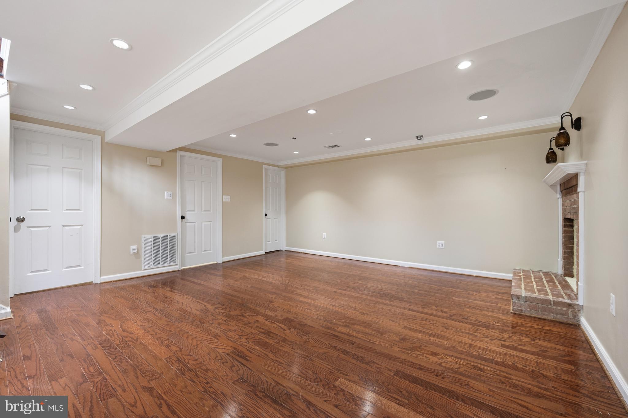 124 Woodland Road Gaithersburg, MD 20877 - Photo 33 of 79 a view of an empty room with wooden floor and staircase