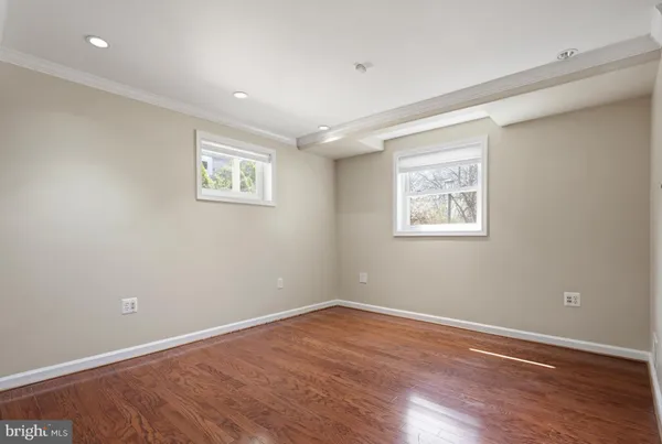 a view of room with hardwood floor and ceiling fan