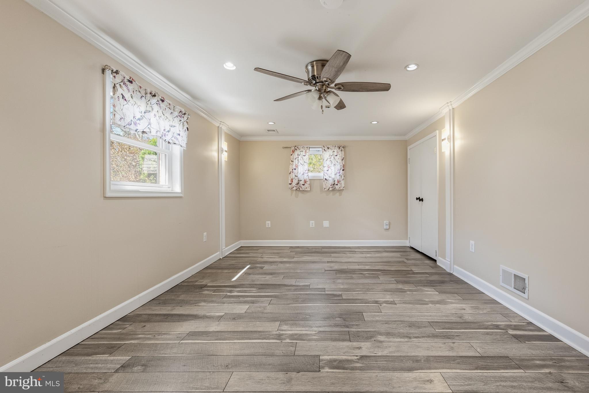 124 Woodland Road Gaithersburg, MD 20877 - Photo 39 of 79 a view of an empty room with window and wooden floor