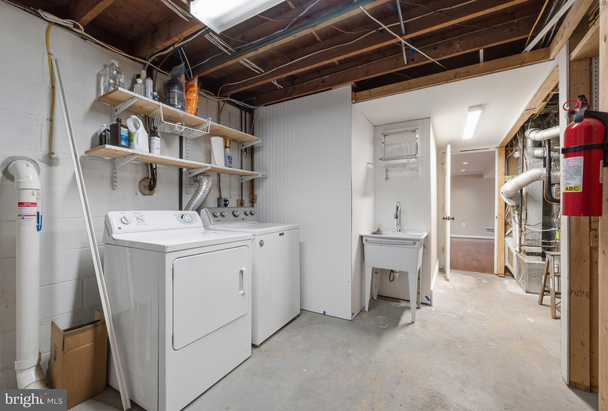 124 Woodland Road Gaithersburg, MD 20877 - Photo 43 of 79 a utility room with cabinets dryer and washer