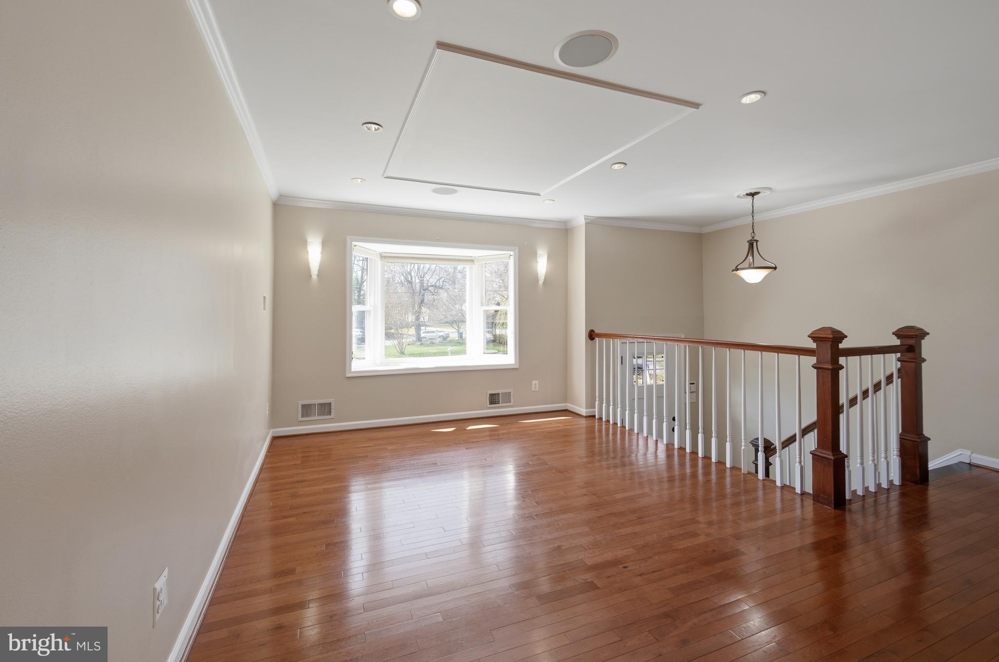 124 Woodland Road Gaithersburg, MD 20877 - Photo 8 of 79 a view of an empty room with wooden floor and a window
