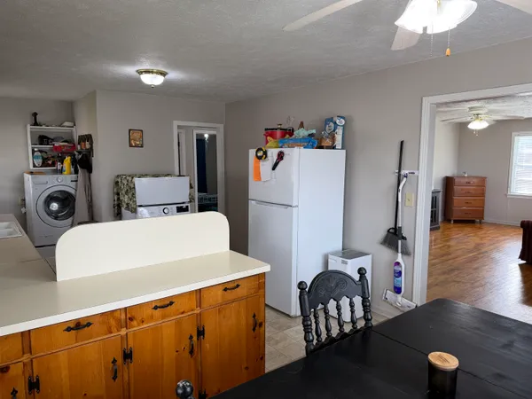 a backyard of a house with yard fire pit barbeque oven and table