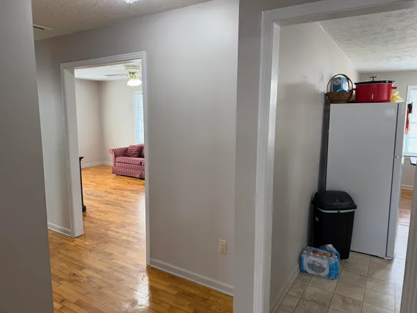 a backyard of a house with barbeque oven and wooden fence
