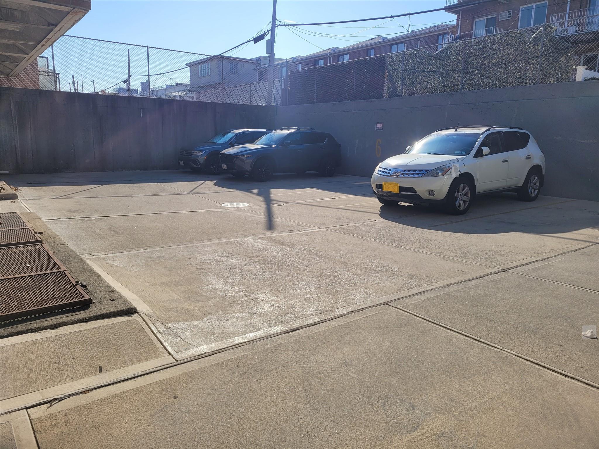 1124 67th Street, Unit A3 Brooklyn, NY 11219 - Photo 19 of 20 View of parking / parking lot with fence