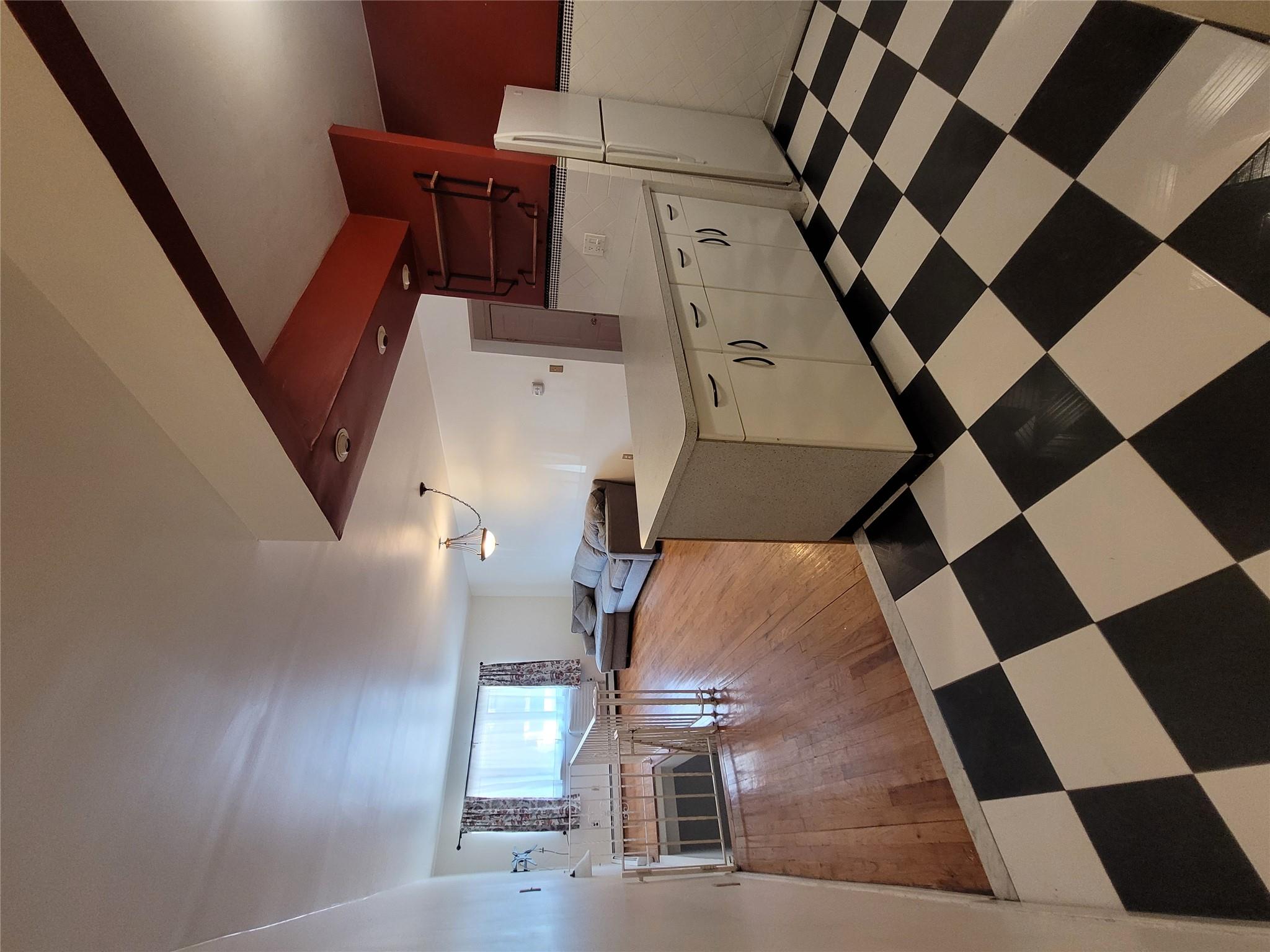 1124 67th Street, Unit A3 Brooklyn, NY 11219 - Photo 5 of 20 Kitchen with fridge, light countertops, light floors, and a peninsula
