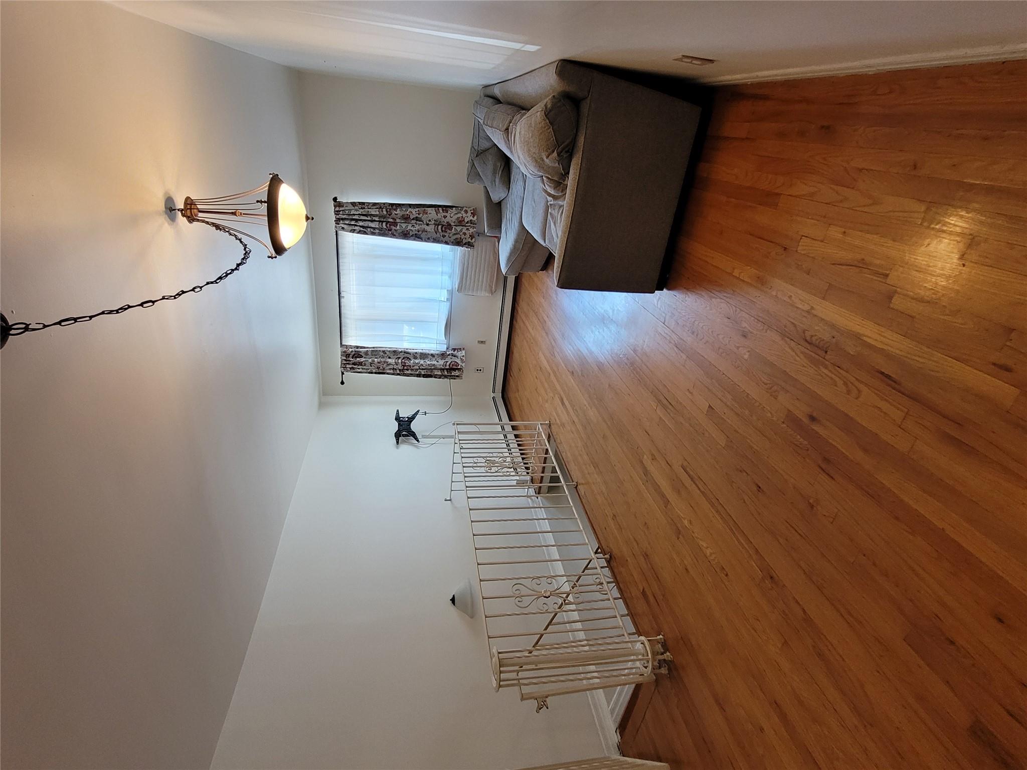 1124 67th Street, Unit A3 Brooklyn, NY 11219 - Photo 7 of 20 Living area with baseboards and hardwood / wood-style floors