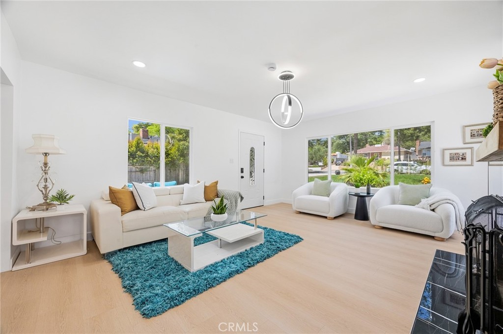 1280 East Woodbury Road Pasadena, CA 91104 - Photo 12 of 40 a living room with fireplace furniture and a large window