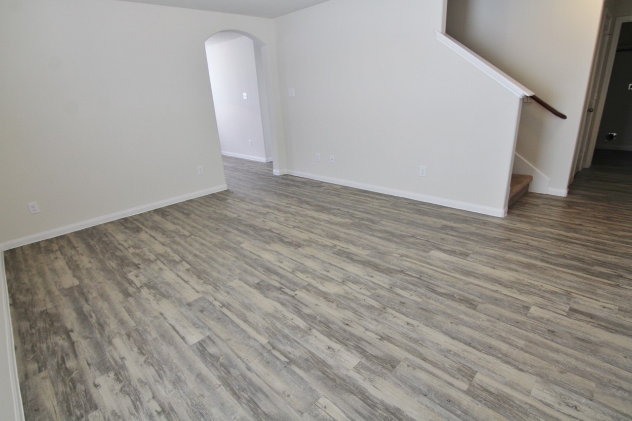 5486 Quail Cove Lane Houston, TX 77053 - Photo 2 of 7 an empty room with wooden floor and a sink