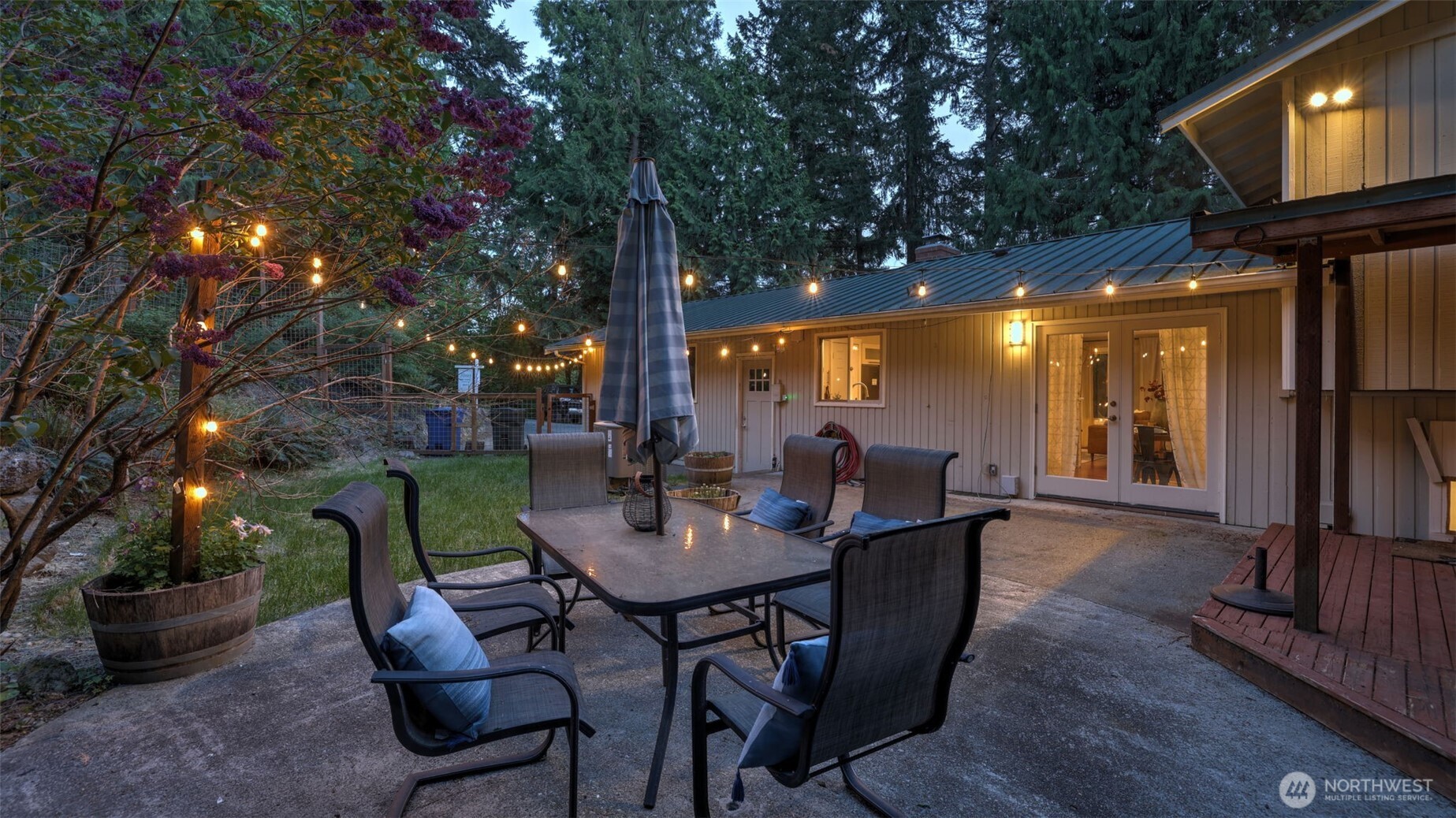 19134 Southeast May Valley Road Issaquah, WA 98027 - Photo 21 of 30 a view of a patio with table and chairs and potted plants