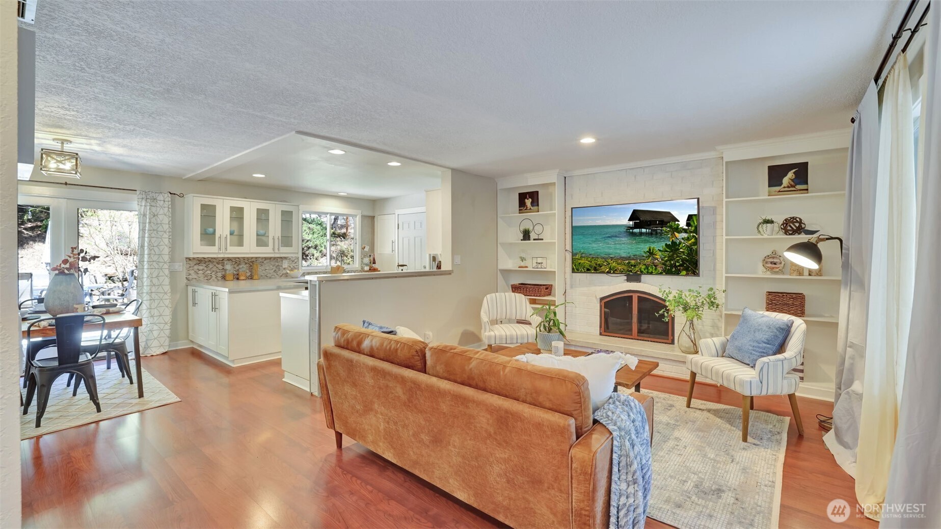 19134 Southeast May Valley Road Issaquah, WA 98027 - Photo 3 of 30 a living room with furniture a dining table and kitchen view