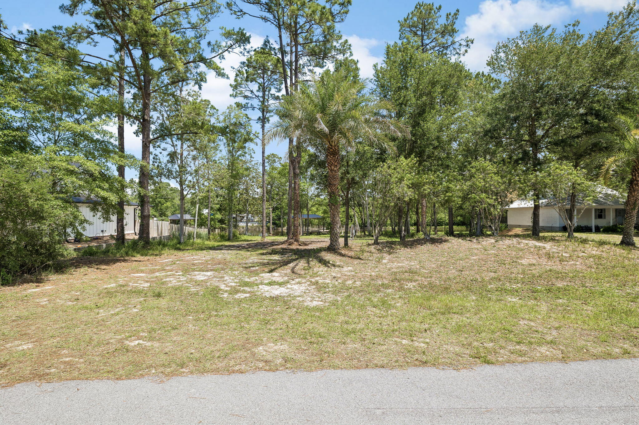 92 Waterside Lane Freeport, FL 32439 - Photo 19 of 28 a backyard of a house with trees and outdoor space
