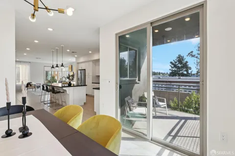 a living room with furniture and a large window with garden view