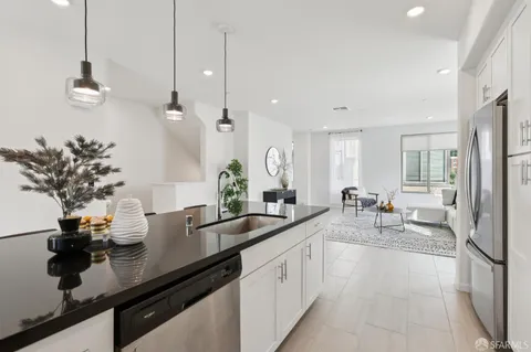 a kitchen with sink and refrigerator