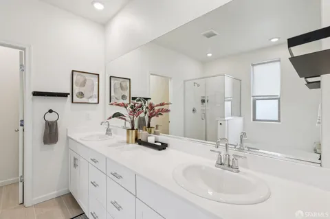 a bathroom with double vanity sinks double vanity tub shower and mirror