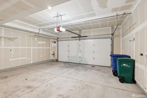 a view of a livingroom with gym equipment and a window