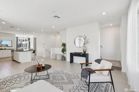 a living room with furniture kitchen view and a table