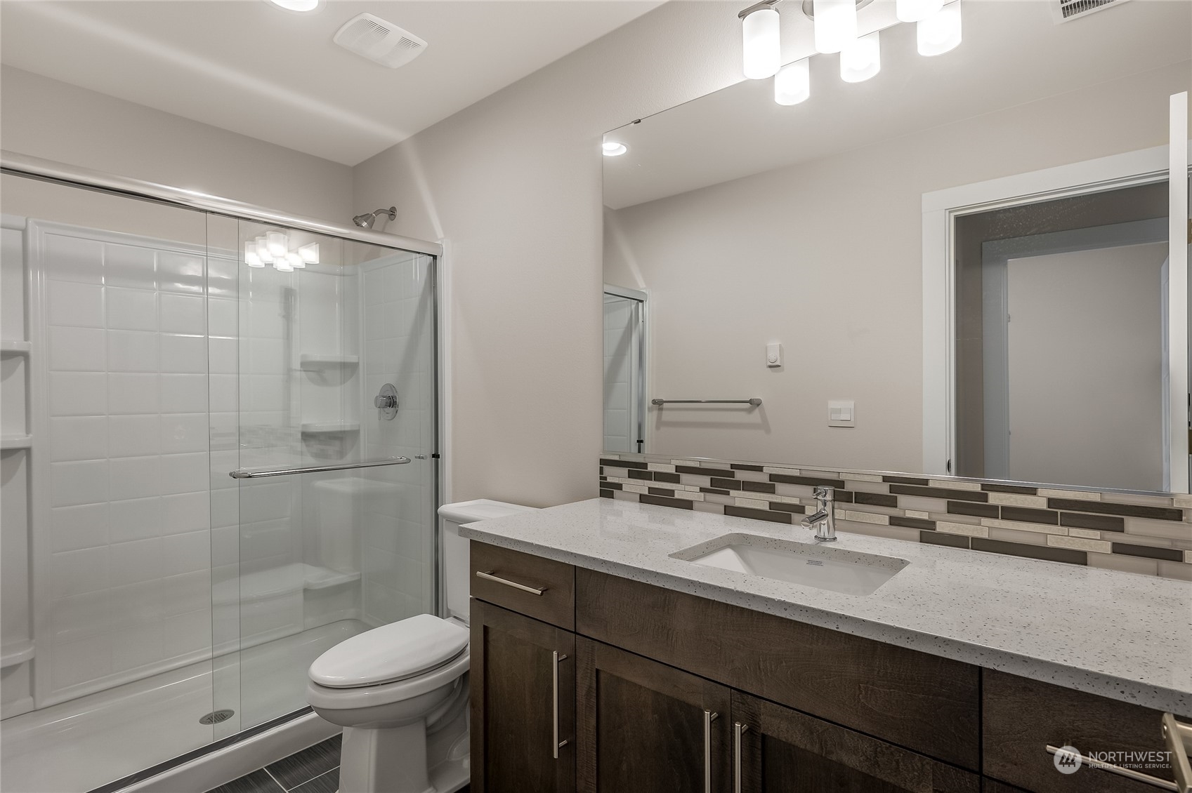 19 178th Place Southwest Bothell, WA 98012 - Photo 29 of 31 a bathroom with a sink a toilet a mirror and shower