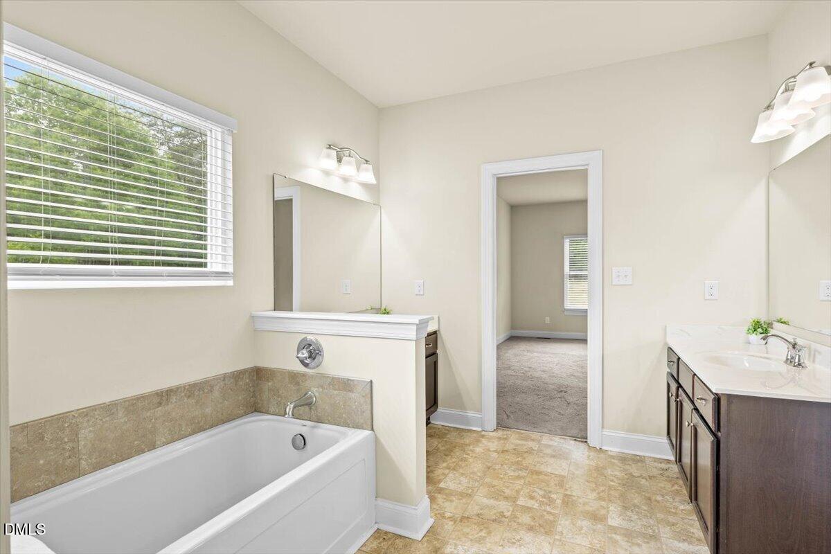 704 Haw River Hopedale Road Burlington, NC 27217 - Photo 25 of 49 a bathroom with a bathtub and a sink