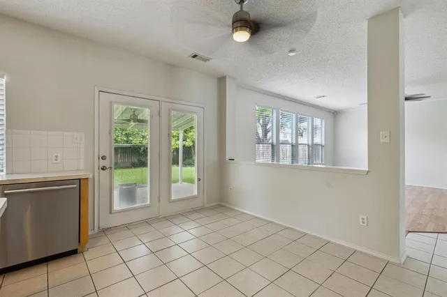 a view of an empty room with window and cabinet