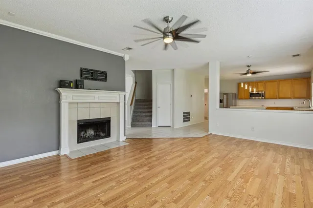 a view of an empty room with a fireplace and a window