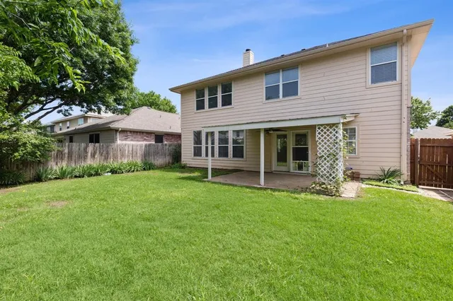 a view of a house with a yard and sitting area