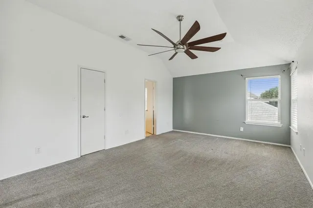 a view of a livingroom with a ceiling fan and window