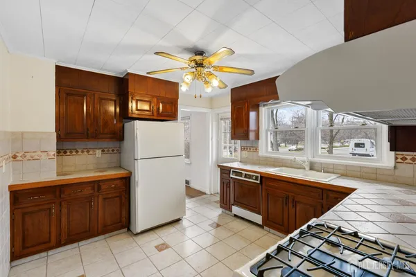 a kitchen with stainless steel appliances granite countertop a sink a stove microwave and cabinets