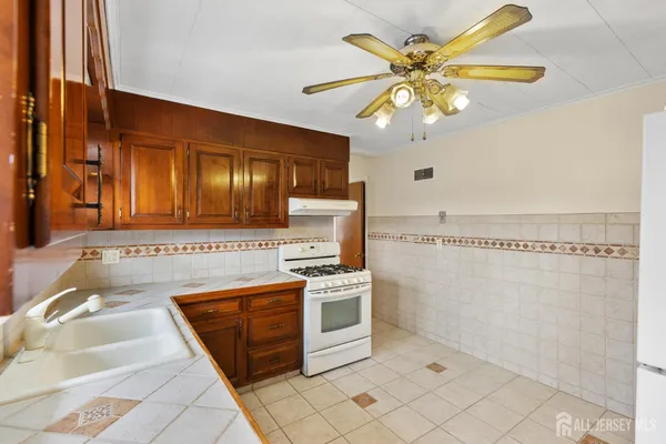 a kitchen with a stove a sink and a refrigerator