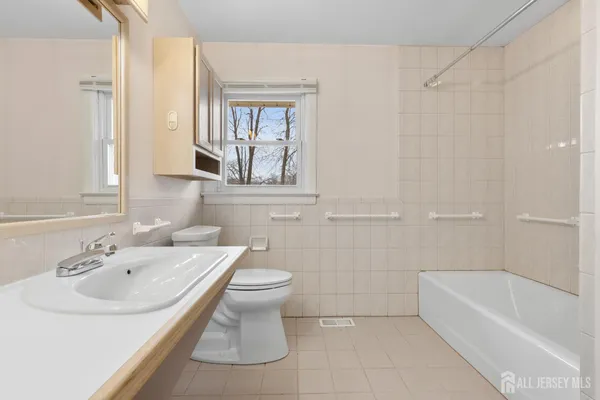 a bathroom with a sink a toilet and bathtub