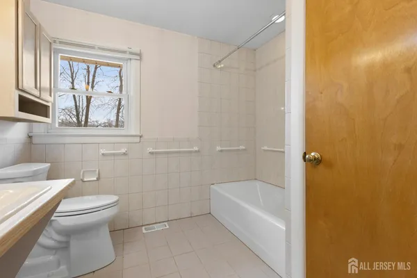 a bathroom with a toilet and a bathtub
