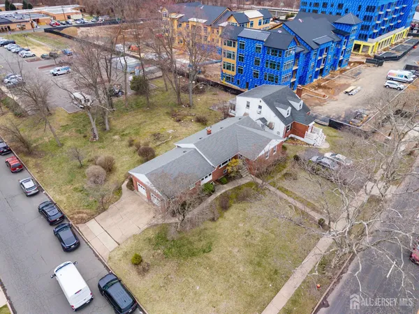 an aerial view of a house with a yard