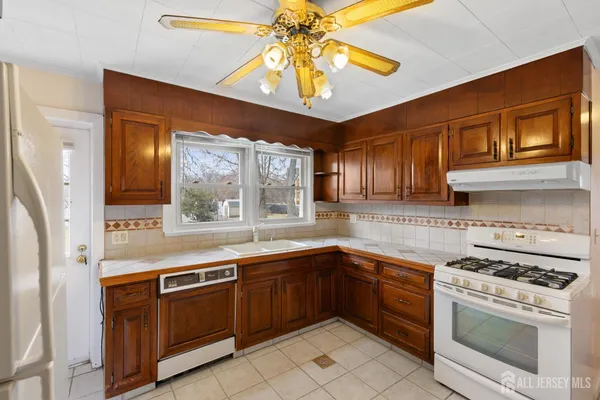 a kitchen with a stove sink and cabinets