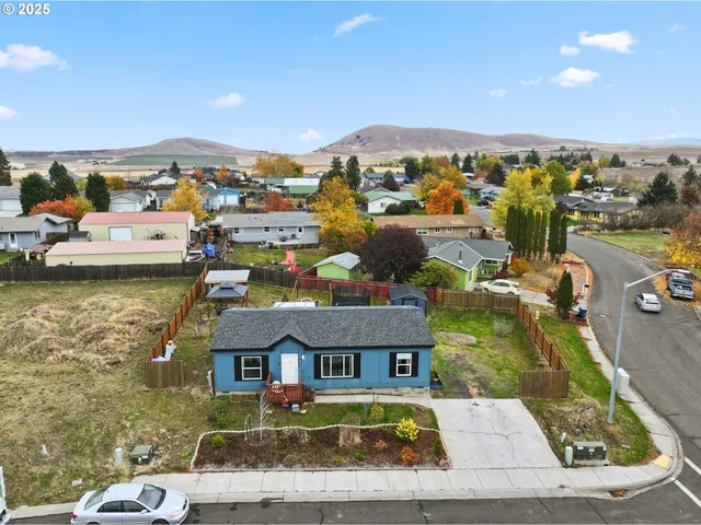 an aerial view of residential houses with outdoor space