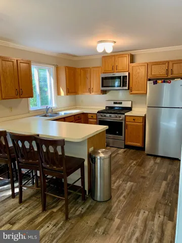 a kitchen with a stove a sink and a refrigerator
