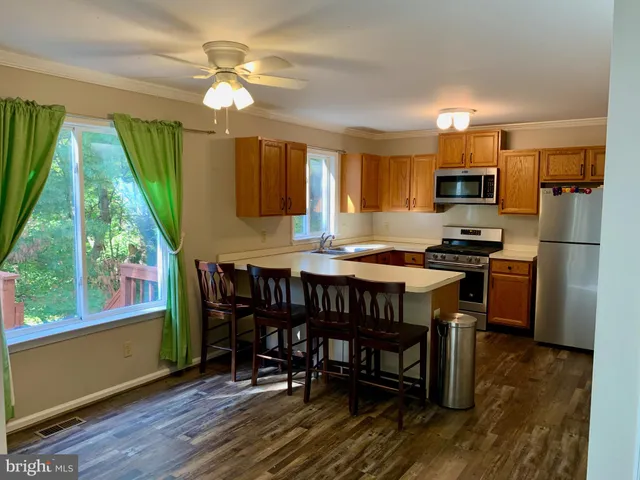 a kitchen with a table chairs refrigerator and microwave