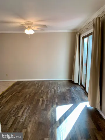 a view of a room with wooden floor and staircase