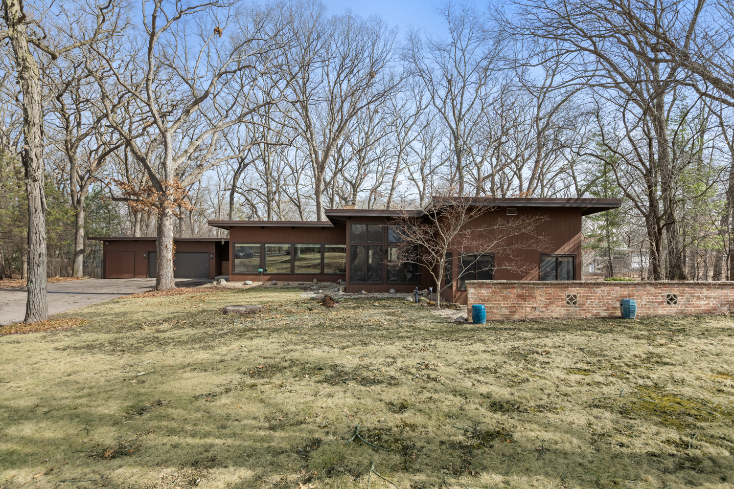 a view of a house with a yard covered with trees