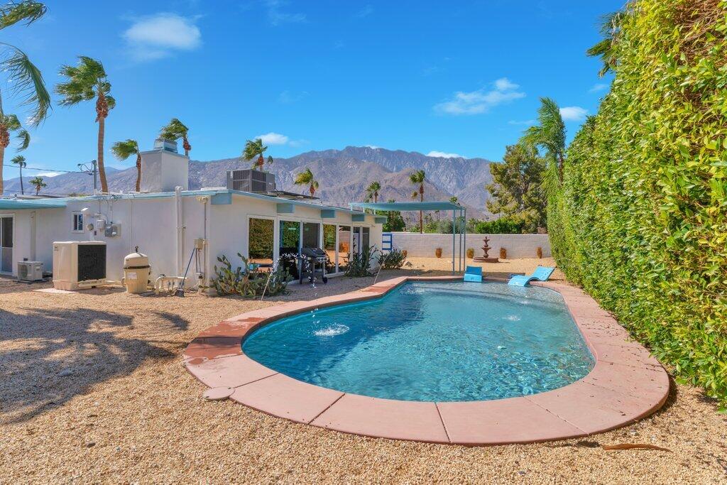600 East Alexander Way Palm Springs, CA 92262 - Photo 9 of 43 a view of a swimming pool with a sitting space
