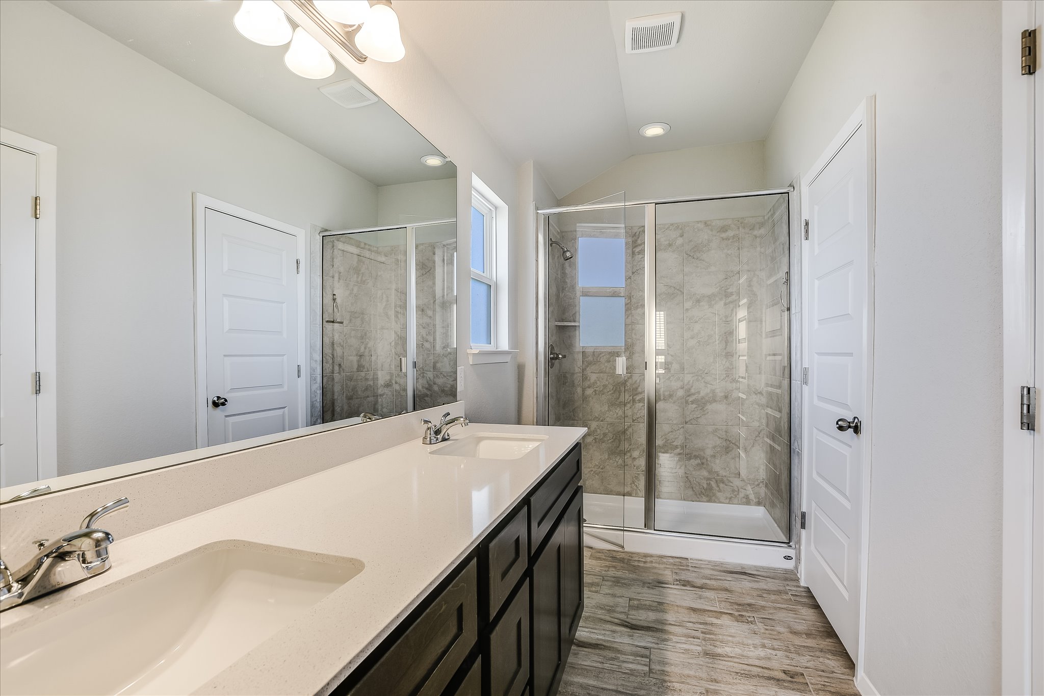 204 Crescent Street Georgetown, TX 78626 - Photo 7 of 12 a spacious bathroom with a shower sink and mirror