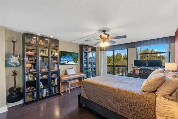 a bedroom with a large bed and a bookshelf
