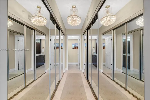 a view of a hallway with glass door and windows