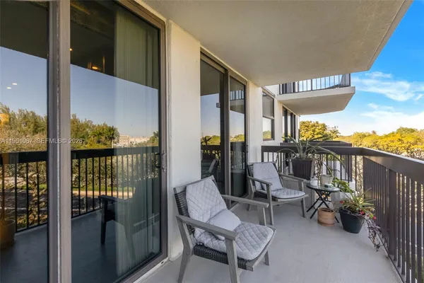 a view of a balcony with chairs