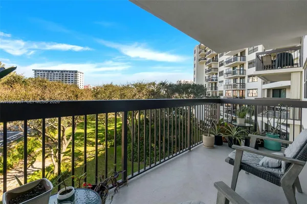 a view of a balcony with chairs and a table